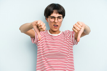 Young caucasian woman with a short hair cut isolated showing thumb down and expressing dislike.