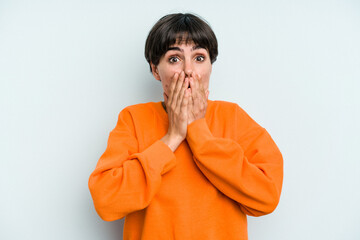 Young caucasian woman with a short hair cut isolated shocked, covering mouth with hands, anxious to discover something new.