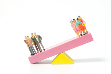 The balance between men and women on seesaw wooden blocks. Depicted in a conceptual image by a...