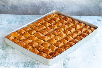 Walnut baklava. Tray baklava on stone background. Turkish cuisine. close up