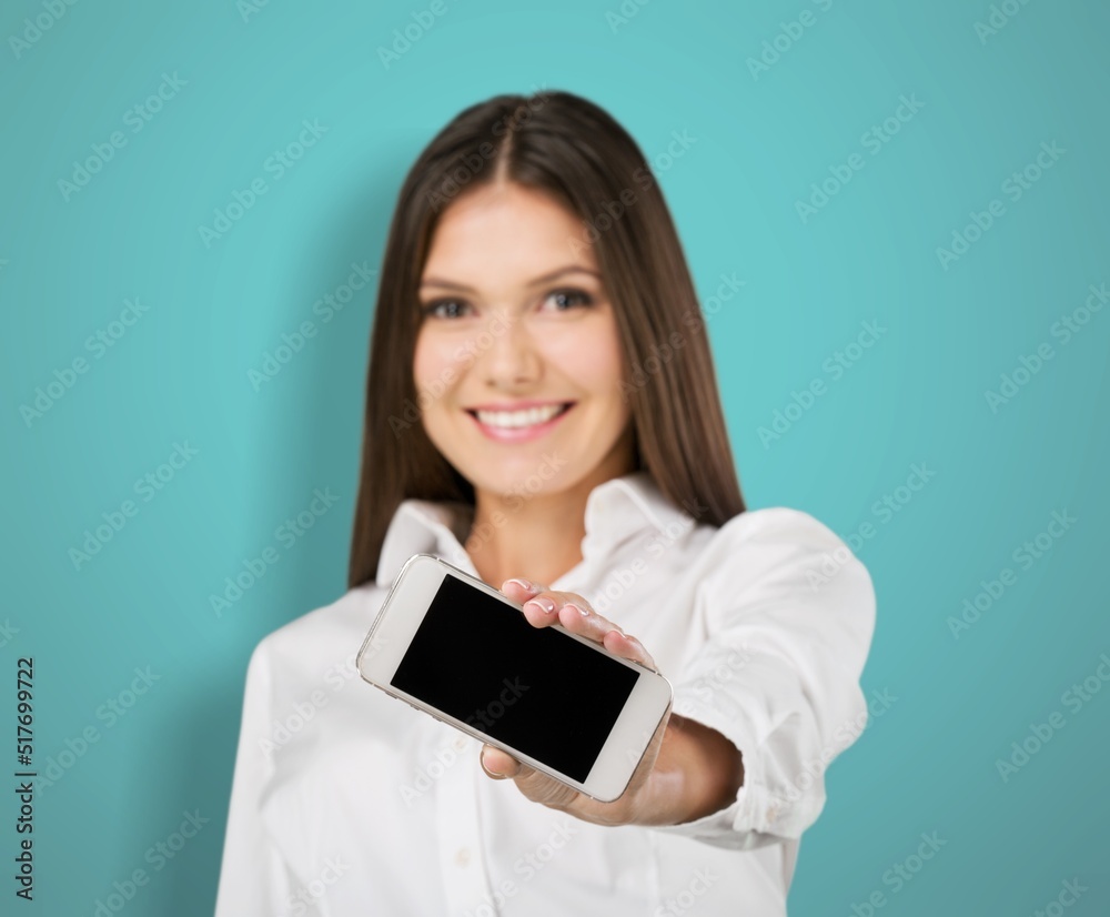 Poster Happy young woman with smartphone on background. Blank screen mobile phone for graphic montage.