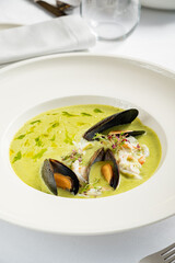 cream soup with mussels and herbs
