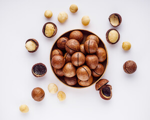 fresh macadamia nuts on a white acrylic background