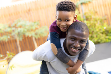 Image of smiling african american boy within the garden
