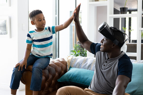 Image of african american father and son high five