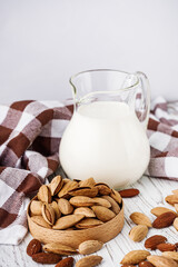 almond milk on a white wooden rustic background