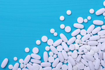 Heap of pills on blue
