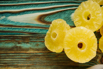 delicious dried pineapple on a wooden rustic background