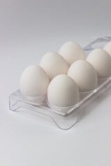 Chicken eggs in a tray on a white background. Ingredients for cooking