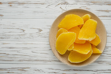 delicious dried mango on a white wooden rustic background