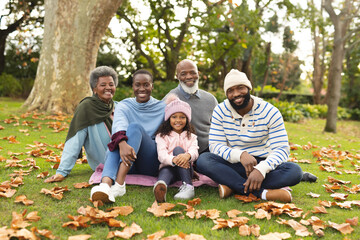Image of happy african american multi generation family in autumn garden - Powered by Adobe