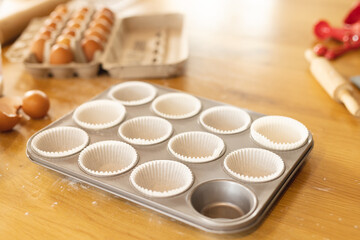 Image of baking tray prepared for cupcakes lying on table