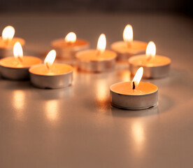 Obraz na płótnie Canvas Set of the burning orange aroma candles on the table