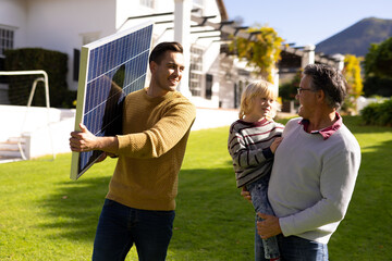 Image of caucasian father with solar panel, grandfather and grandson