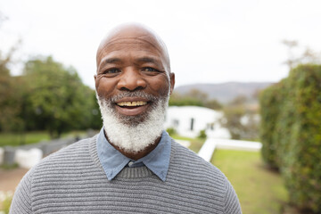 Image of happy african american senior man posing at camera - Powered by Adobe