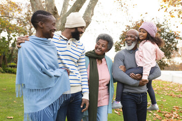Image of happy multi generation african american family having fun outdoors in autumn - obrazy, fototapety, plakaty