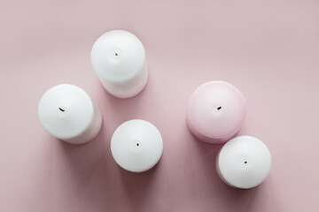 Set of white and pink extinguished candles, top view