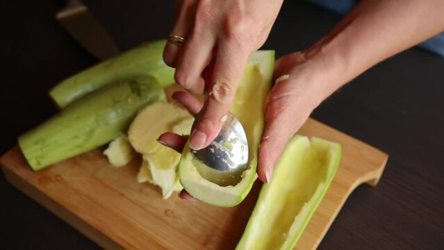 woman hands close up carving zucchini at home