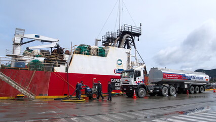 Fuel tanker refueling a barge at the pier in Ushuaia, Argentina