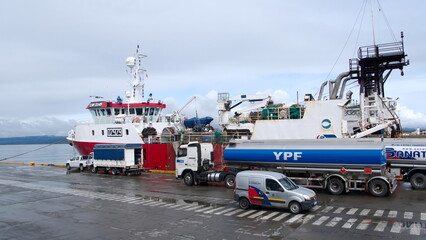 Fuel tanker refueling a barge at the pier in Ushuaia, Argentina