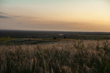 A sunny sunset.Dramatic sunset over the horizon. Above the meadows. Red sky background. beautiful rays of the sun.Landscape
