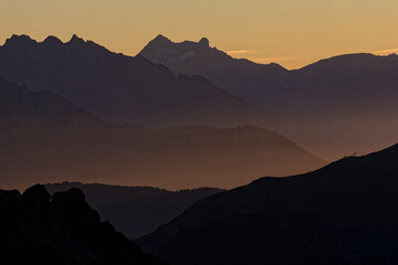 Golden lights of dawn on moutains and fogs near Chamonix.
