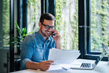 Portrait of smiling young male manager working remotely