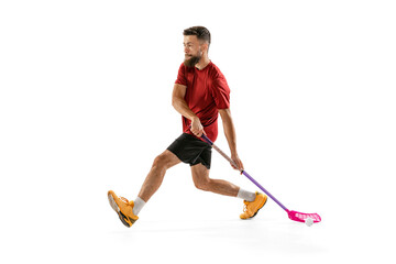 Floorball male player with floorball stick training isolated on white studio background. Sport,...