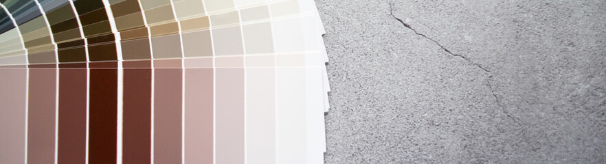 Banner paint samples colors swatch for interior design. Gray concrete background, earth tone colors
