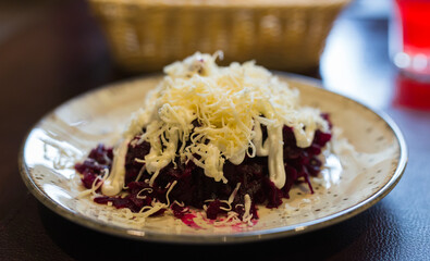 grated boiled beets with garlic, cheese and mayonnaise