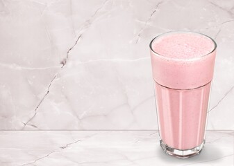 Tasty iced pink milk. Cold sweet drink mix with milk and ice in glass