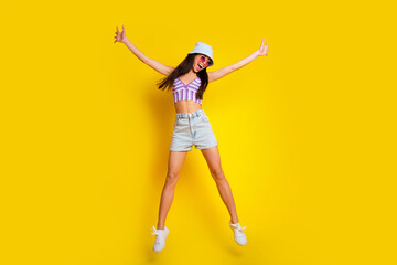 Fototapeta na wymiar Full length photo of sweet charming girl dressed swimsuit bra cap jumping high like star isolated yellow color background