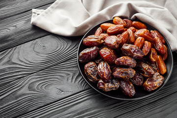 juicy royal dates on a black wooden rustic background