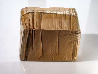 crumpled parcel cardboard box pasted over with adhesive tape from China
