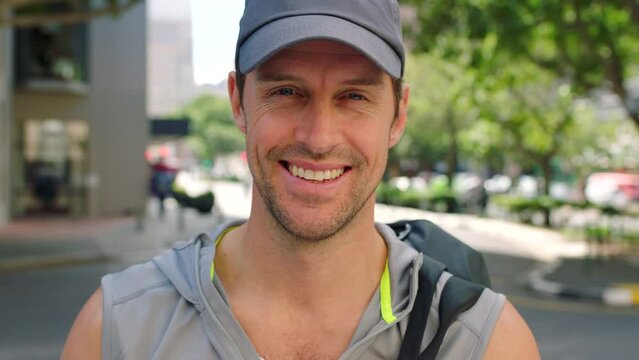 Fit man looking positive and ready to exercise or workout. Feeling good and living an active healthy lifestyle. Portrait of a sporty young man wearing a cap, smiling and working out in an urban city
