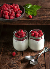 raspberry yogurt with raspberries on the wooden table