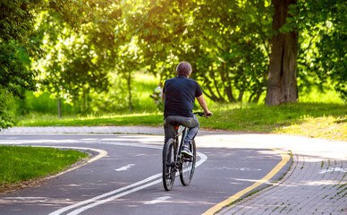 Cyclist ride on the bike path in the city Park
