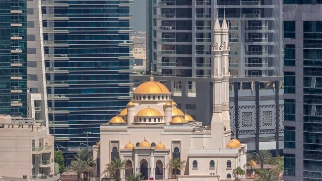 Dubai Marina skyline with Mohammad Bin Ahmed Al Mulla mosque aerial timelapse. Skyscrapers with glass surface on a background