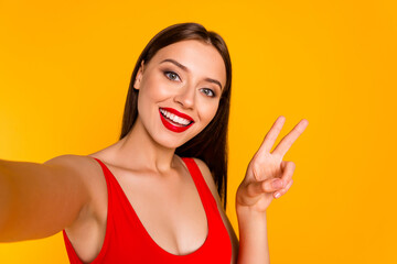 Photo of cool pretty lady dressed bodysuit recording self video showing v-sign isolated yellow...
