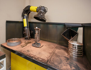 Sifting copper powder through a sieve.
