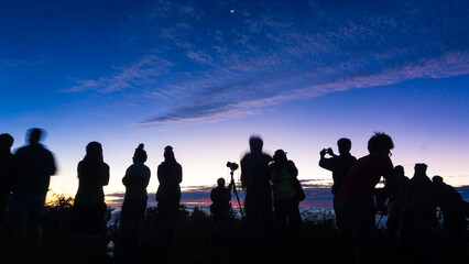 Fototapeta na wymiar Silhouette group of people enjoying sunrise new year camping on mountain