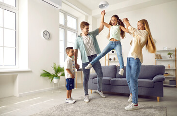 Happy family with children playing crazy games at home. Cheerful, carefree mother, father, son and...