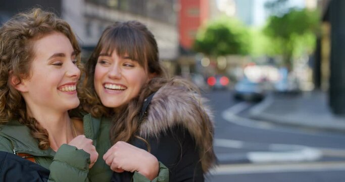 Portrait of two smiling friends hugging and looking happy in the city. Faces of cheerful sisters bonding and having fun while traveling together. Excited females embracing in loving playful greeting