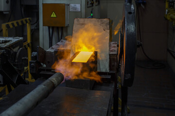 Pouring hot liquid gold into molds.