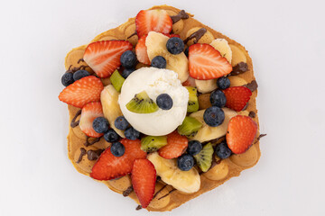 Waffle with ice cream and fresh fruits.