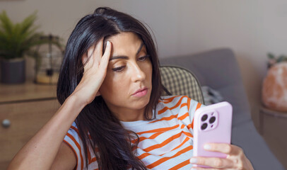 Beautiful Sad ,Worried  Unhappy  Woman Looking at her Smartphone 