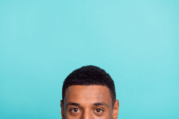 Photo of attractive funky young man peek empty space isolated turquoise color background