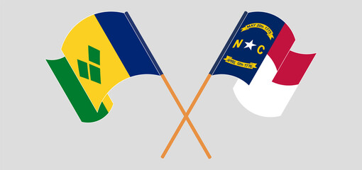 Crossed and waving flags of Saint Vincent and the Grenadines and The State of North Carolina