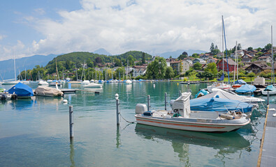 Fototapeta na wymiar beautiful harbour Spiez with moored boats, lake Thunersee switzerland