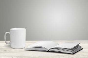 Retro antique journal with paper pages with a cup of tea on rustic wood